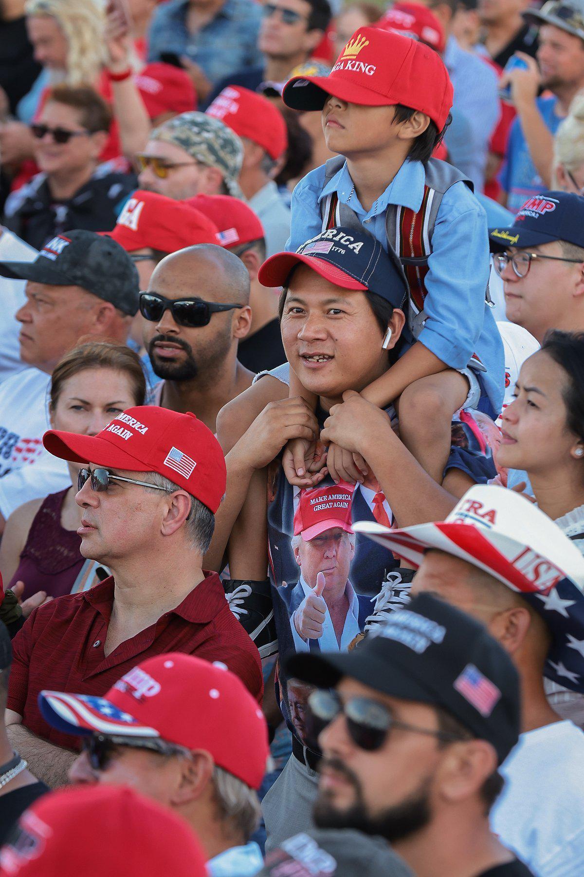 Trump supporters stand for several hours as they wait for the arrival of former President Donald Trump at the Miami-Dade County Fair and Exposition on Sunday, November 6, 2022. Trump and a collection of other national and local Republicans campaigned with U.S. Sen. Marco Rubio on the eve of the Nov. 8 election.