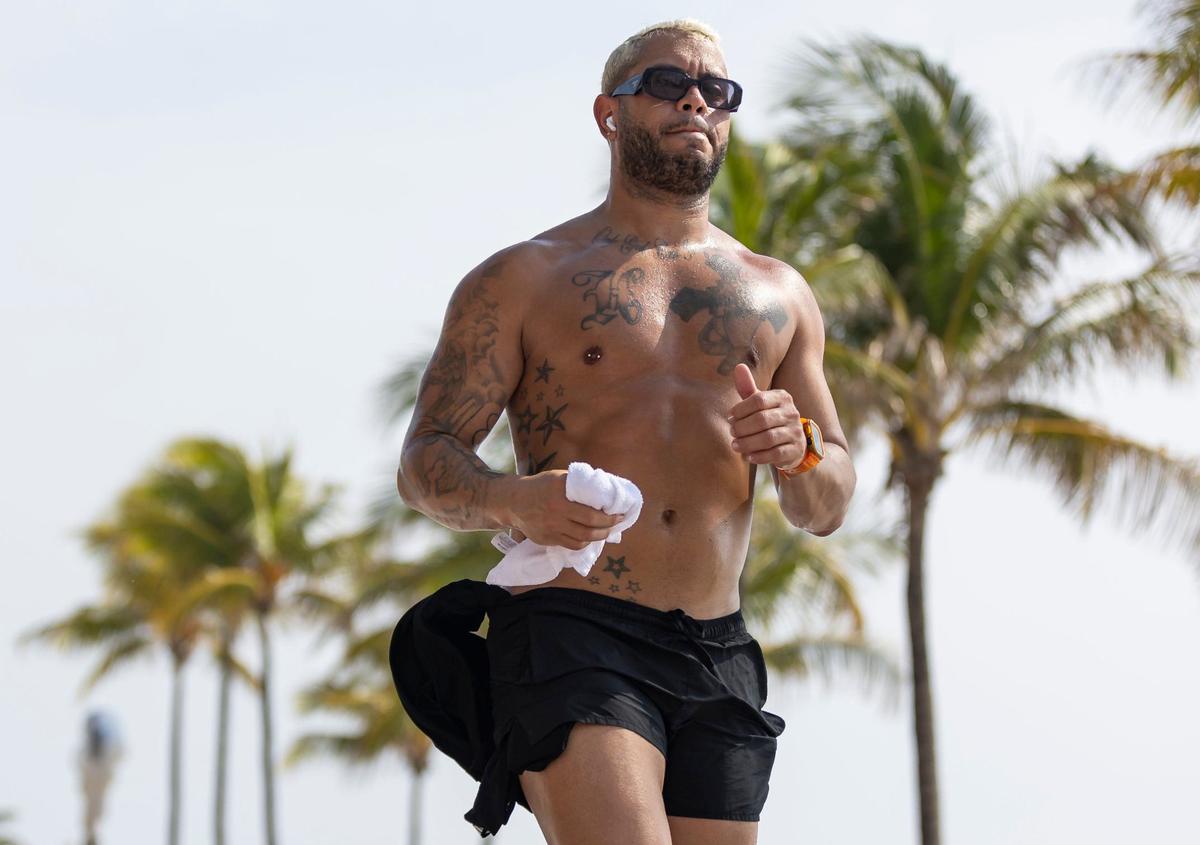A man makes his way down Hollywood Beach Broadwalk as temperatures soar into the 90s on Tuesday, May 14, 2024, in Hollywood, Fla.