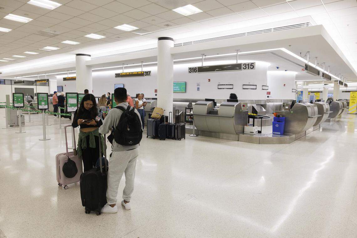 People check in to Viva Aerobus flights at a new ticketing pod in the Central Terminal during the day on Tuesday, Aug. 19, 2025, at the Miami International Airport in Miami, Fla. The airport recently finished construction on three new pods, sections of ticketing counters, in the Central Terminal.
