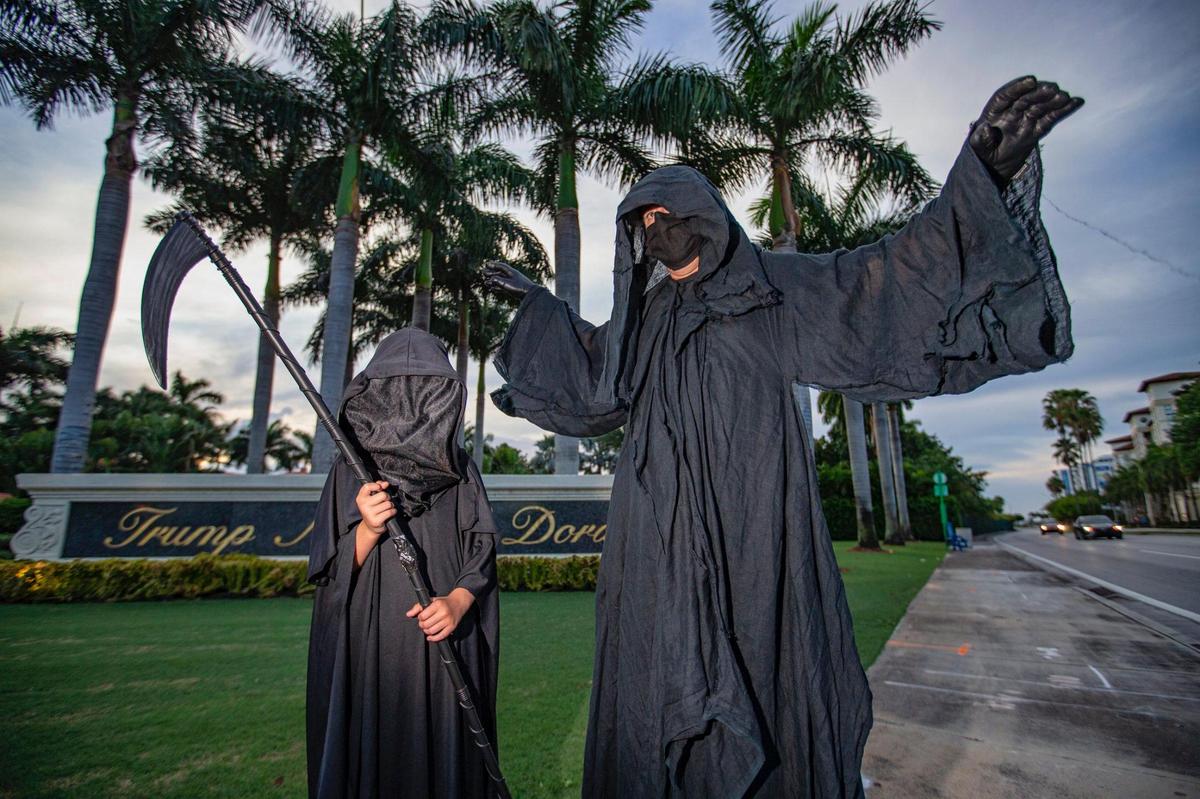 The ‘Grim Reaper,’ Florida Lawyer Daniel W Uhlfelder with his daughter Daisy visits Trump National Doral to raise awareness of new cases of COVID in Florida that he says is because of the failure of leaders and people in general to prevent the spread of the pandemic on Saturday, June 20, 2020 in Miami.
