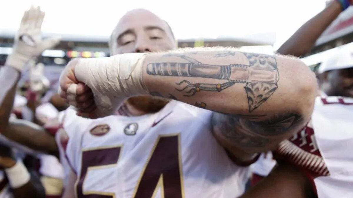 In 2018, Alec Eberle, of the Florida State Seminoles shows off his tomahawk tattoo after the game against the Louisville Cardinals.
