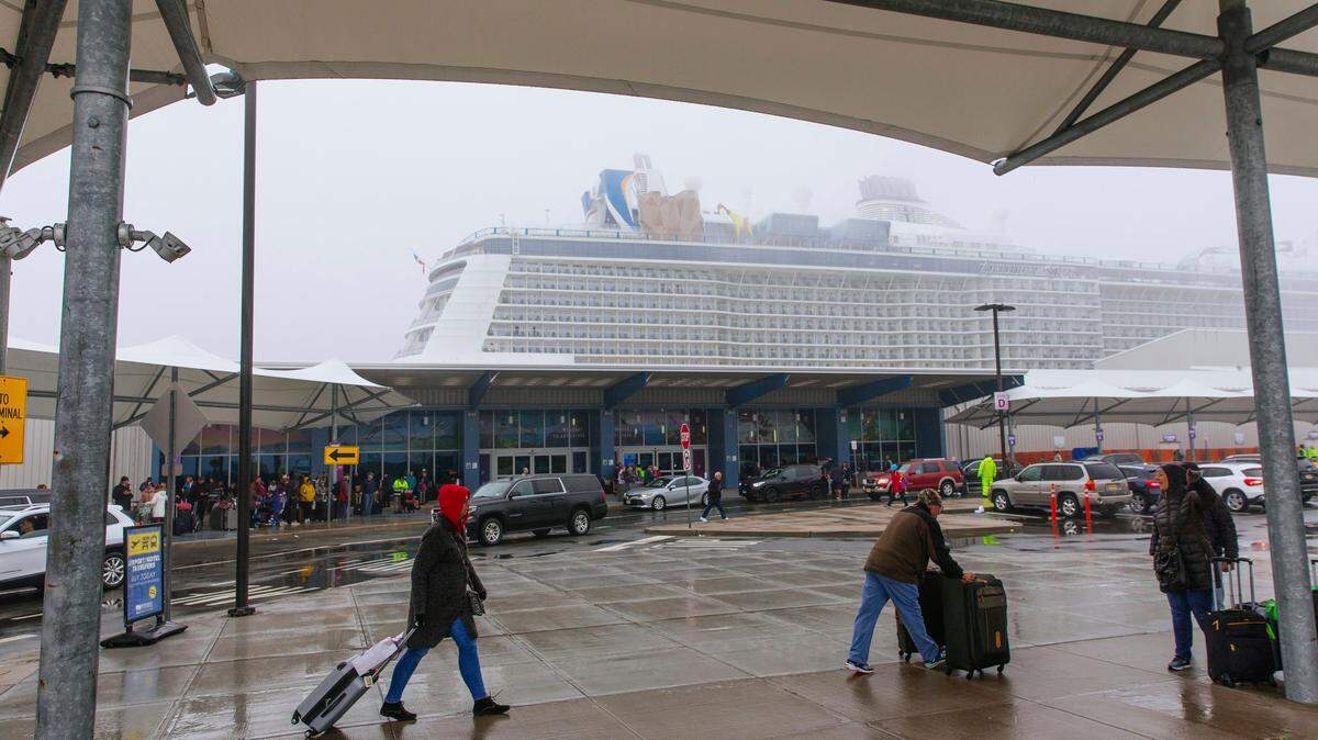 Passengers disembark from the cruise ship Anthem of the Seas at the Cape Liberty Cruise Port on Friday in Bayonne, New Jersey. Four passengers were hospitalized to be tested for the virus.