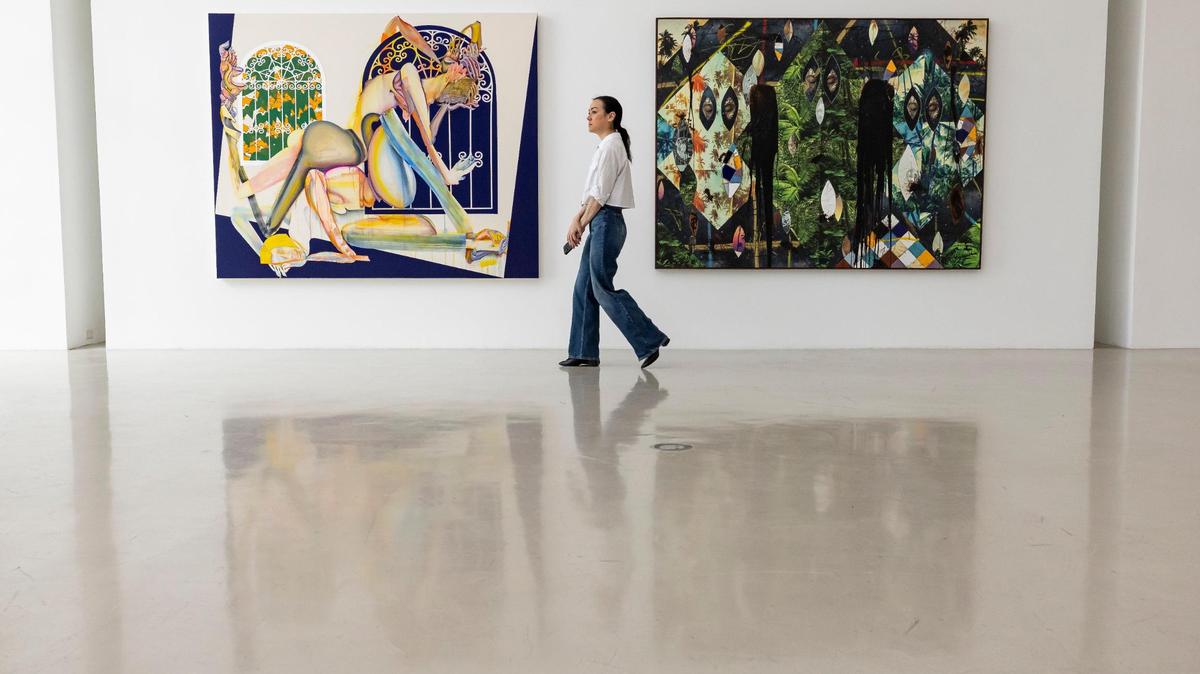 Jessica Stanley, Christie’s public relations director walks past works by Christina Quarles, left, and Rashid Johnson that were owned by Rosa de la Cruz at the de la Cruz Collection on Monday, April 8, 2024, in Miami, Florida. Christies’s will begin selling works from De la Cruz’s collection in May.