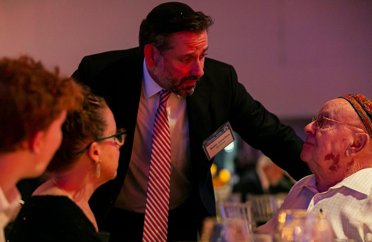 Judah Samet, far right, a Holocaust survivor, talks with Rabbi Jonathan Berkum during the Greater Miami Jewish Federation’s Main Event at the Hilton Downtown Miami on Monday. Samet, a member of the Tree of Life synagogue in Pittsburgh, survived a shooting in 2018 where a gunman opened fired killing 11 worshipers at the temple.