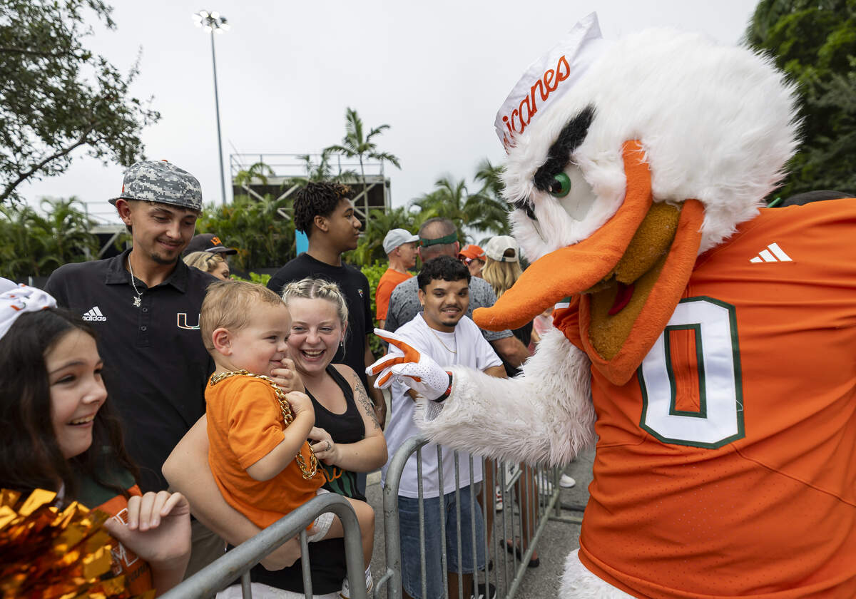 Miami Hurricanes mascot Sebastian the Ibis greets fans as they wait for players to arrive at Hard Rock Stadium before the team’s NCAA football game against the Bethune-Cookman Wildcats on Saturday, Sept. 6, 2025, in Miami Gardens, Fla.
