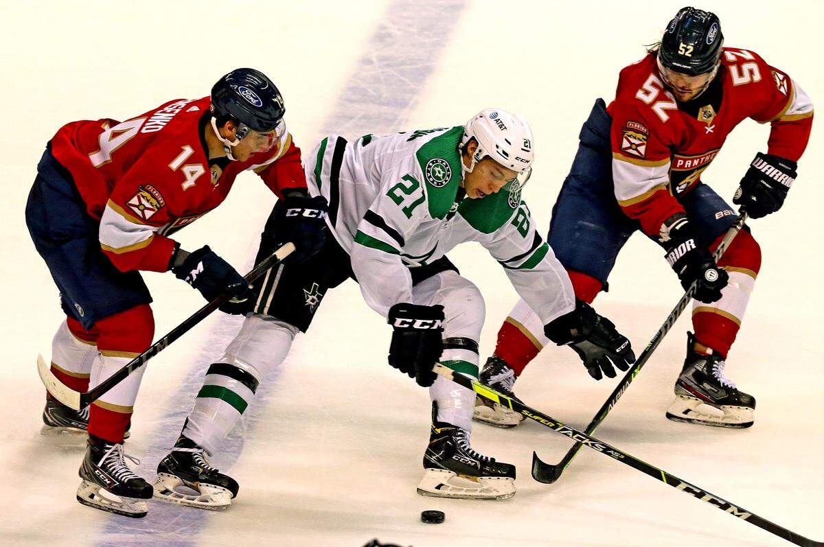 Florida Panthers Grigori Denisenko (14) and MacKenzie Weegar (52) and Dallas Stars Jason Robertson (21) in the first period at the BB&T Center in Sunrise, Florida, Monday, May 3, 2021.