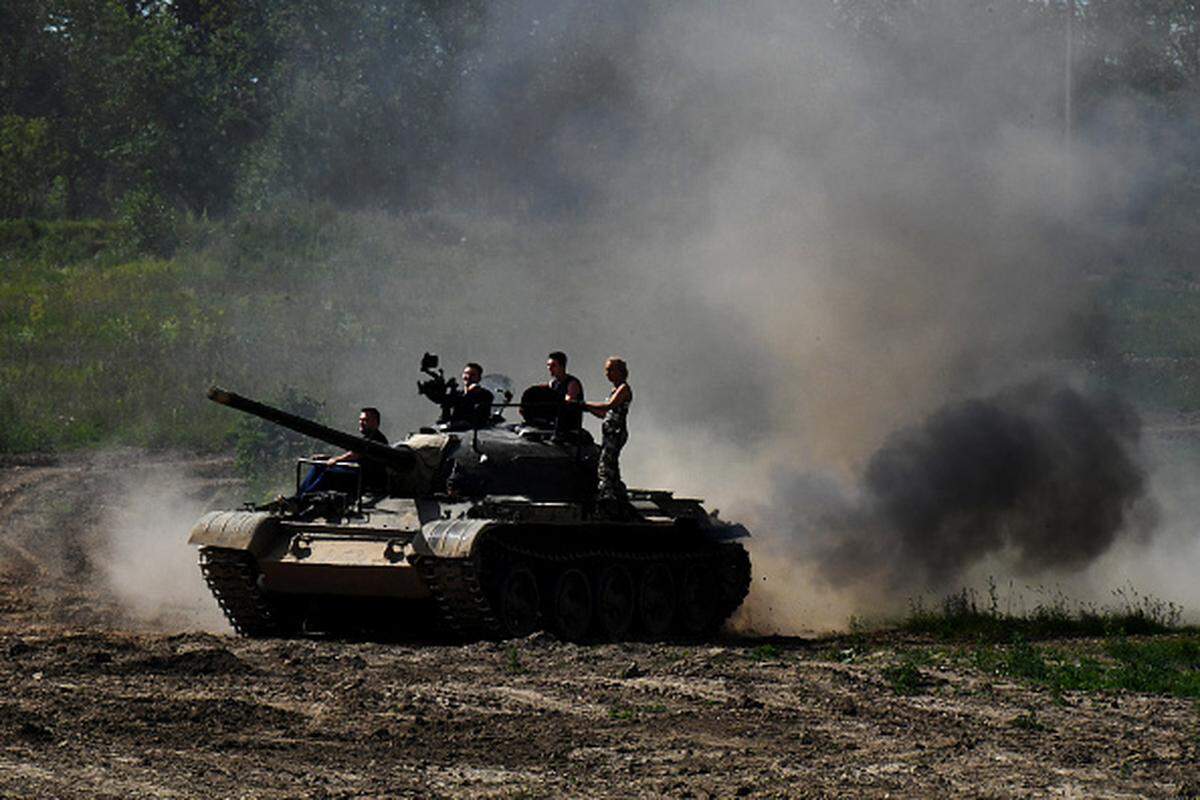 People ride atop a Soviet T-54 tank as they visit the Family Historical tank park in Saint Petersburg, on July 15, 2023. Cuba’s armed forces use T-54 tanks.