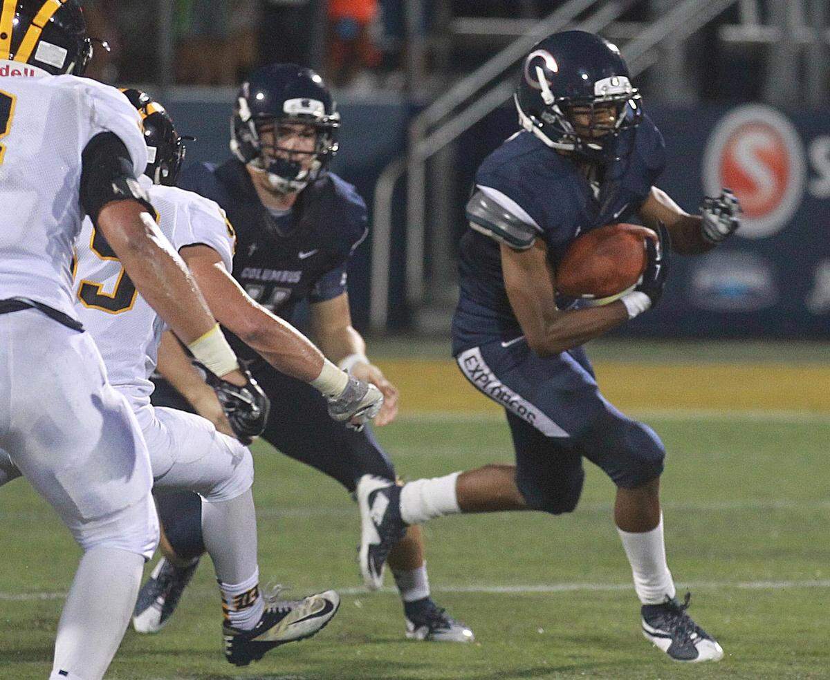 C J Henderson, #5 of Columbus High runs for yards in their game against Belen High at FIU Stadium, Friday, September 25, 2015.