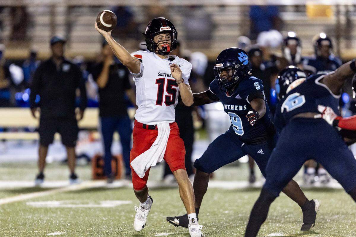 Spartans quarterback James Perrone (15) throws the ball while pressured by Panthers line backer Brandon Howard (9) during the second half of a high school football game between Palmetto and Miami Southridge at Tropical Park on Thursday, September 4, 2025, in Miami, Fla.