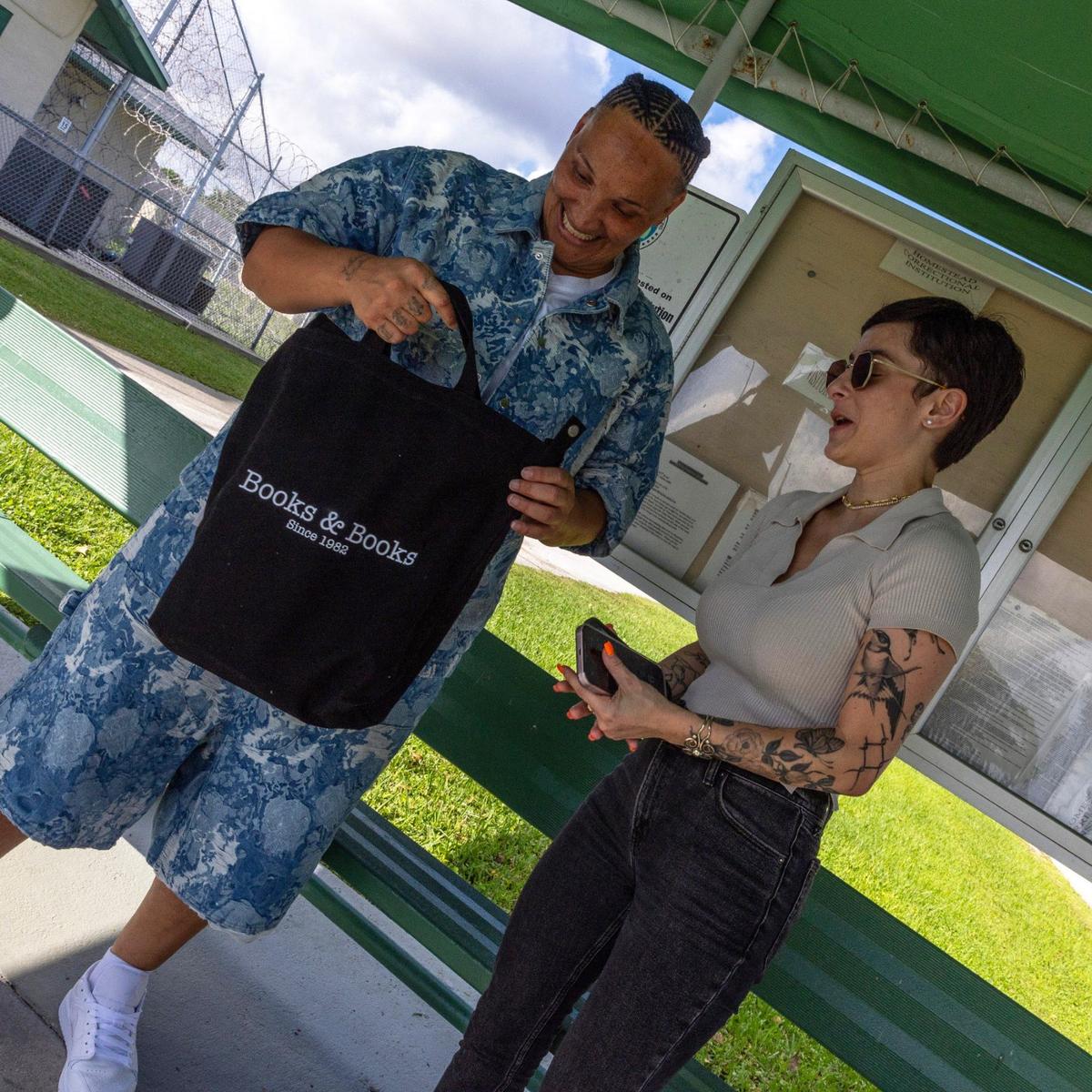 Leeann Parker is handed a bag from Books & Books filled with books by Alyssa Exposito after being released from Homestead Correction Institution on Friday, August 23, 2024.