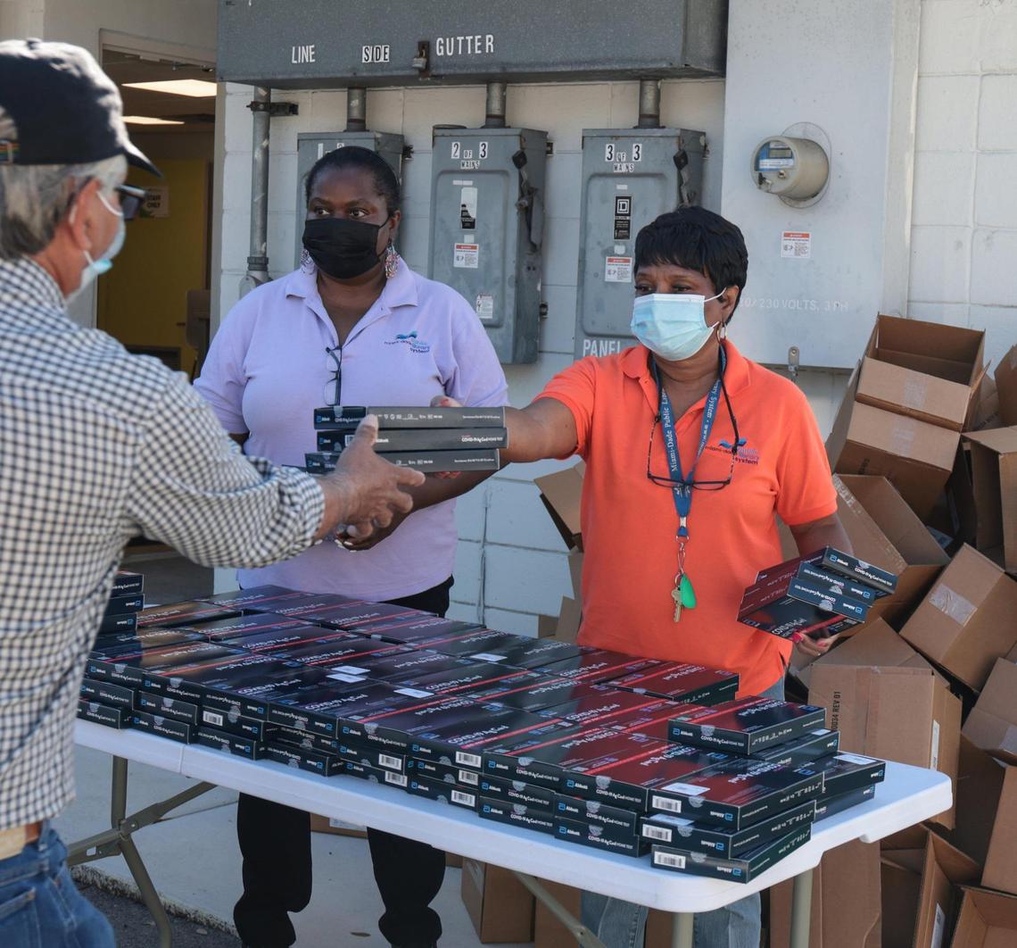 Free take-home COVID-19 tests are handed out by Edison Center Branch employees on Monday, Dec. 27, 2021.