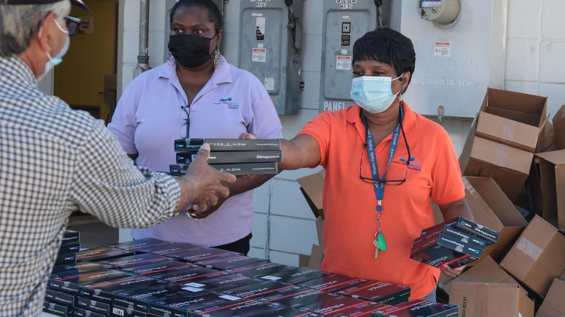 Free take-home COVID-19 tests are handed out by Edison Center Branch employees on Monday, Dec. 27, 2021.