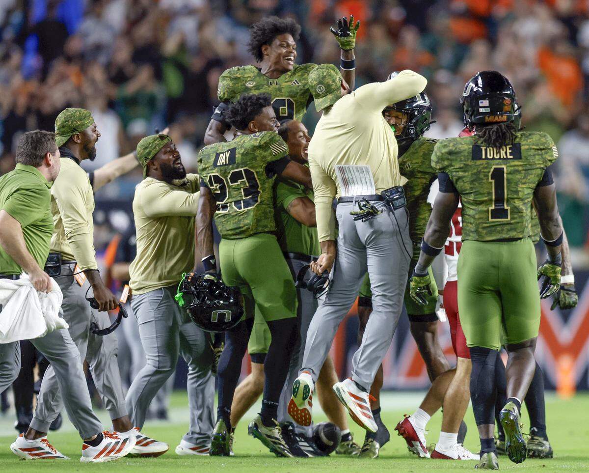 Miami Hurricanes cornerback Xavier Lucas (6) celebrates with teammates after intercepting a Stanford Cardinal pass in the second half during their NCAA football game at Hard Rock Stadium in Miami Gardens, Florida, on Saturday, October 25, 2025.