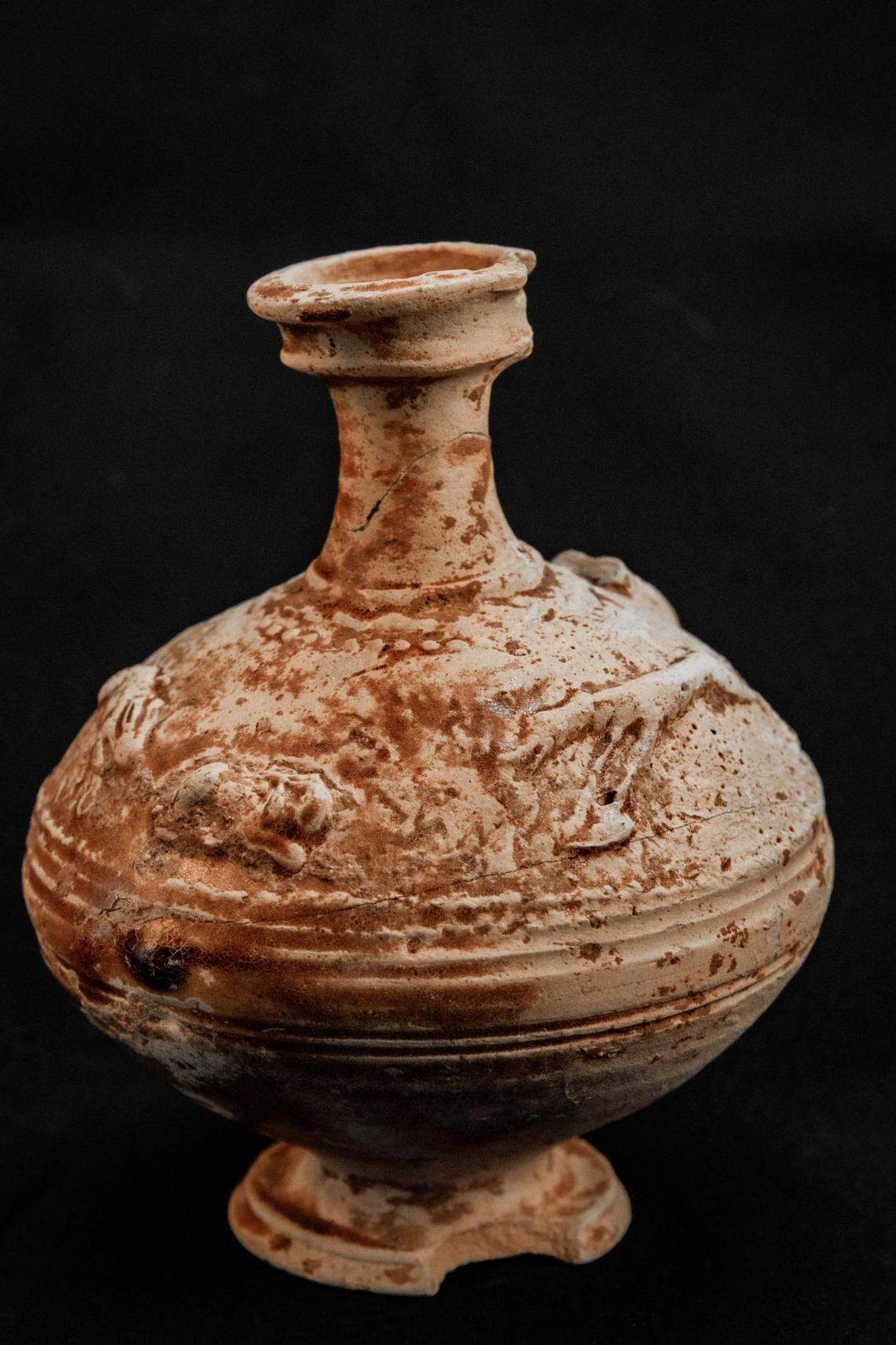 An ancient jug depicting a hunting scene.