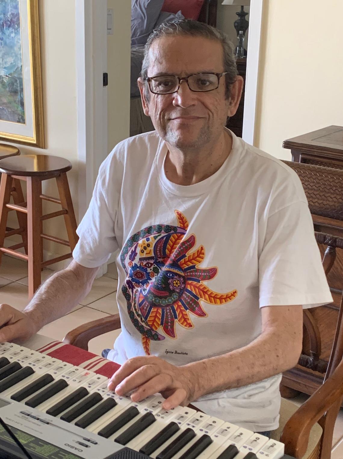 Raul Pino-Lay, a retired pharmacist playing the piano in his Miami home. He sings with the Sylvester Cancer Center Survivorship Choir through virtual sessions.