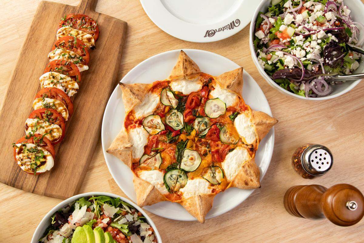 The Star Michele surrounded by salads from Mister 01 Extraordinary Pizza, which just opened a new spot in Bay Harbor Islands.