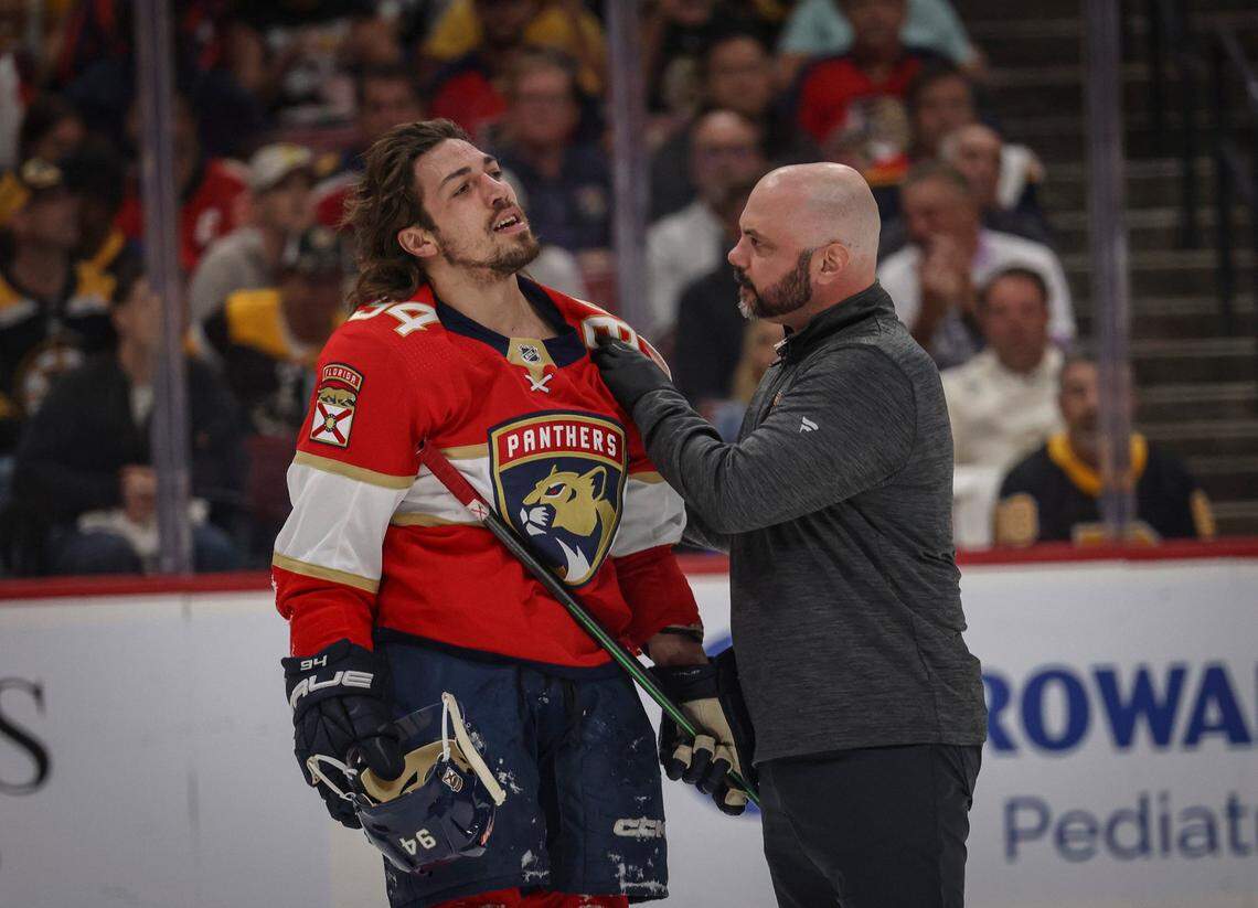 Florida Panthers left wing Ryan Lomberg (94) gets his shoulder iced after being pushed to the ground by his shoulder by Boston Bruins center Pavel Zacha (18) during the first period of Game 4 of a first round NHL Stanley Cup series at FLA Live Arena on Sunday, April 23, 2023, in Sunrise, Fla. The Bruins were up 1-0 at the end of the first period.