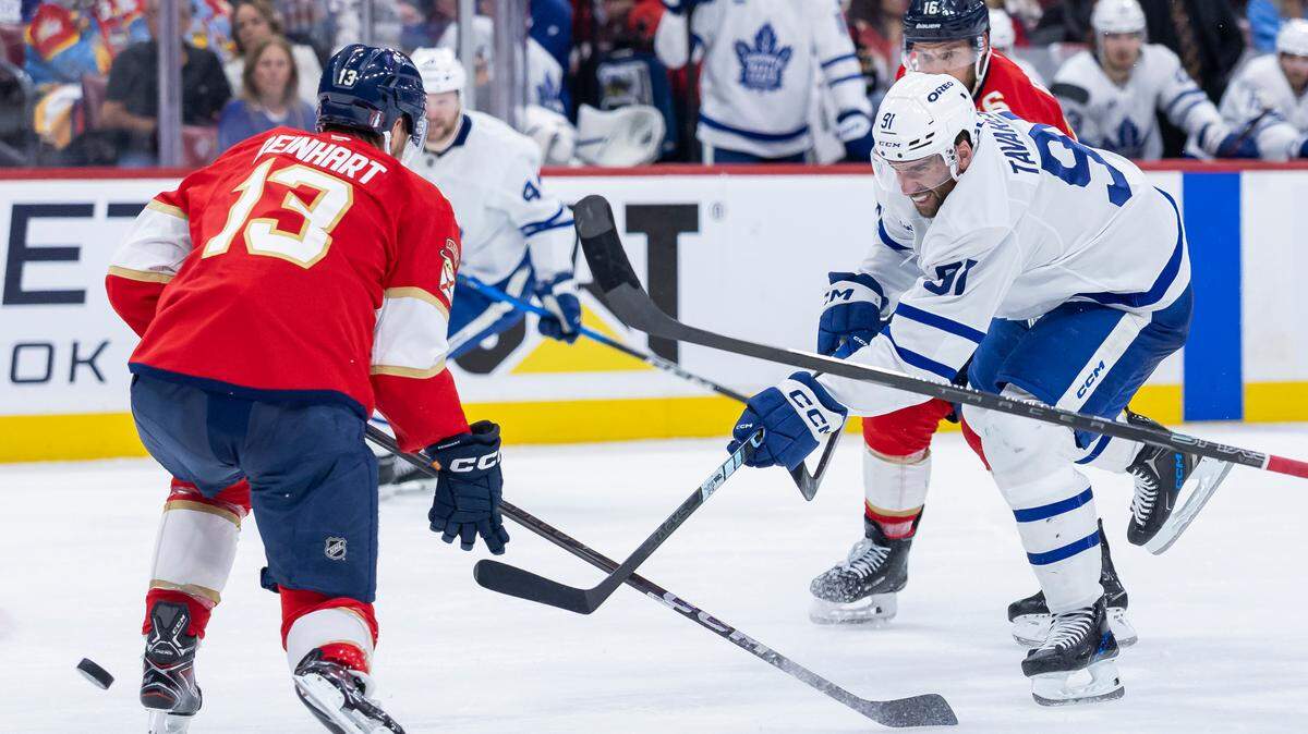 Toronto Maple Leafs center John Tavares (91) shoots the puck as Florida Panthers centers Sam Reinhart (13) and Aleksander Barkov (16) defend in the second period of Game 6 of a second-round Stanley Cup playoffs series at the Amerant Bank Arena on Friday, May 16, 2025, in Sunrise, Fla.