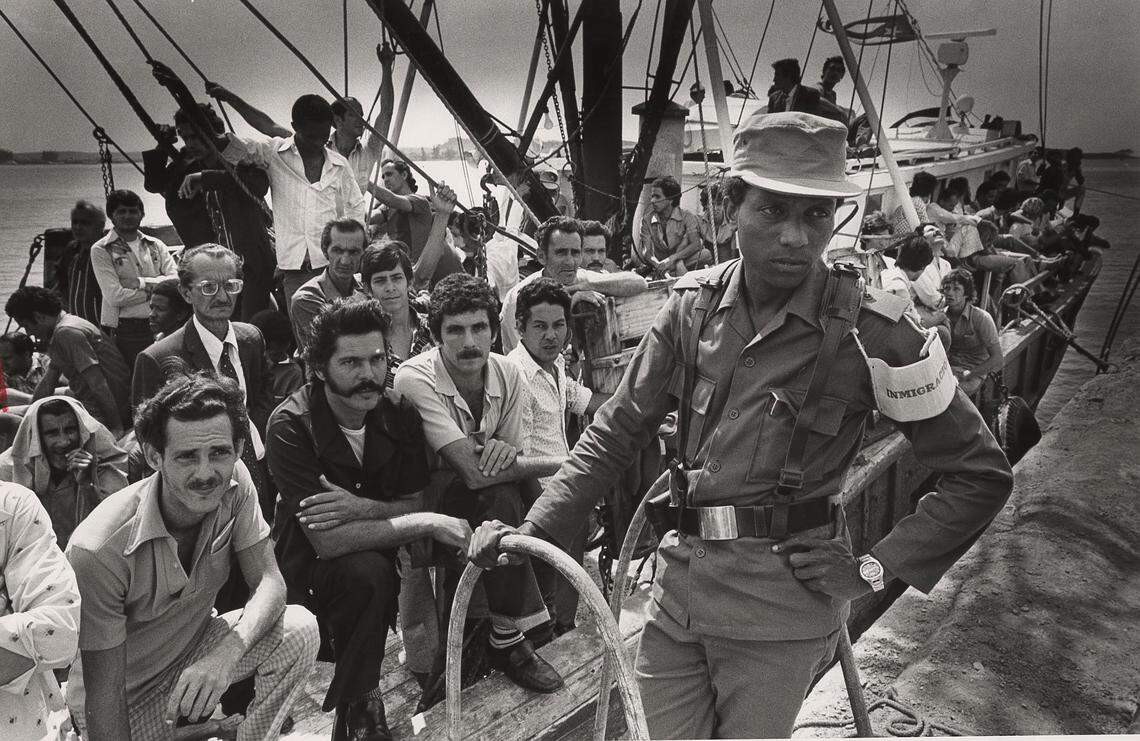 MARIEL, CUBA April, 1980 - A cuban soldier stands guard next to the “Big Baby” a U.S. vessel loaded with Cuban refugees before they set sail from Mariel Harbor to Key West.