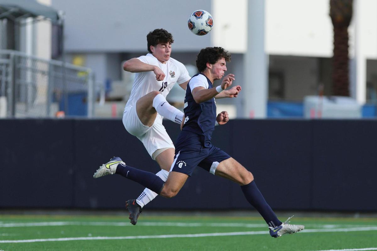Mater Lakes forward Joel Quintana (19) attempts to controls the ball against Gulliver Prep defender Jacob Lombard (22) during the second half of the boys regional championship game at Gulliver Prep in Miami, Florida on Wednesday, February 14, 2024.