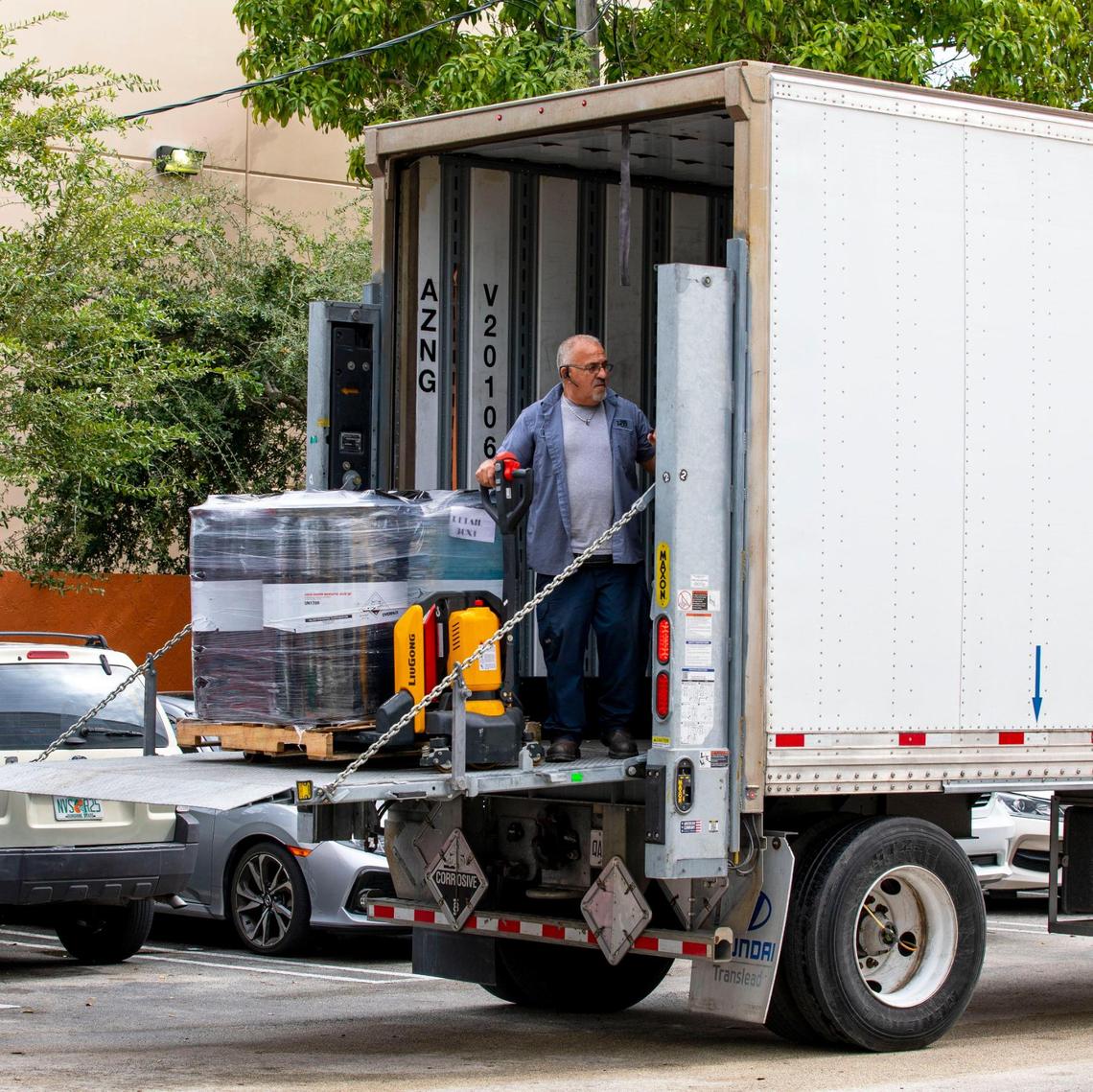 A delivery driver unloads chemicals for the Pinch A Penny off Bird Road in Miami on Saturday, Nov. 13, 2021. A family-owned business, Pinch A Penny began with the Fred Thomas family opening a discount store within an industrial park in Clearwater, Florida.