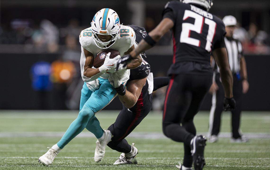 Miami Dolphins wide receiver Nick Westbrook-Ikhine (18) runs with the ball as Atlanta Falcons linebacker JD Bertrand (40) tackles in the first half of their NFL game at Mercedes-Benz Stadium on Sunday, Oct. 26, 2025, in Atlanta, Ga.