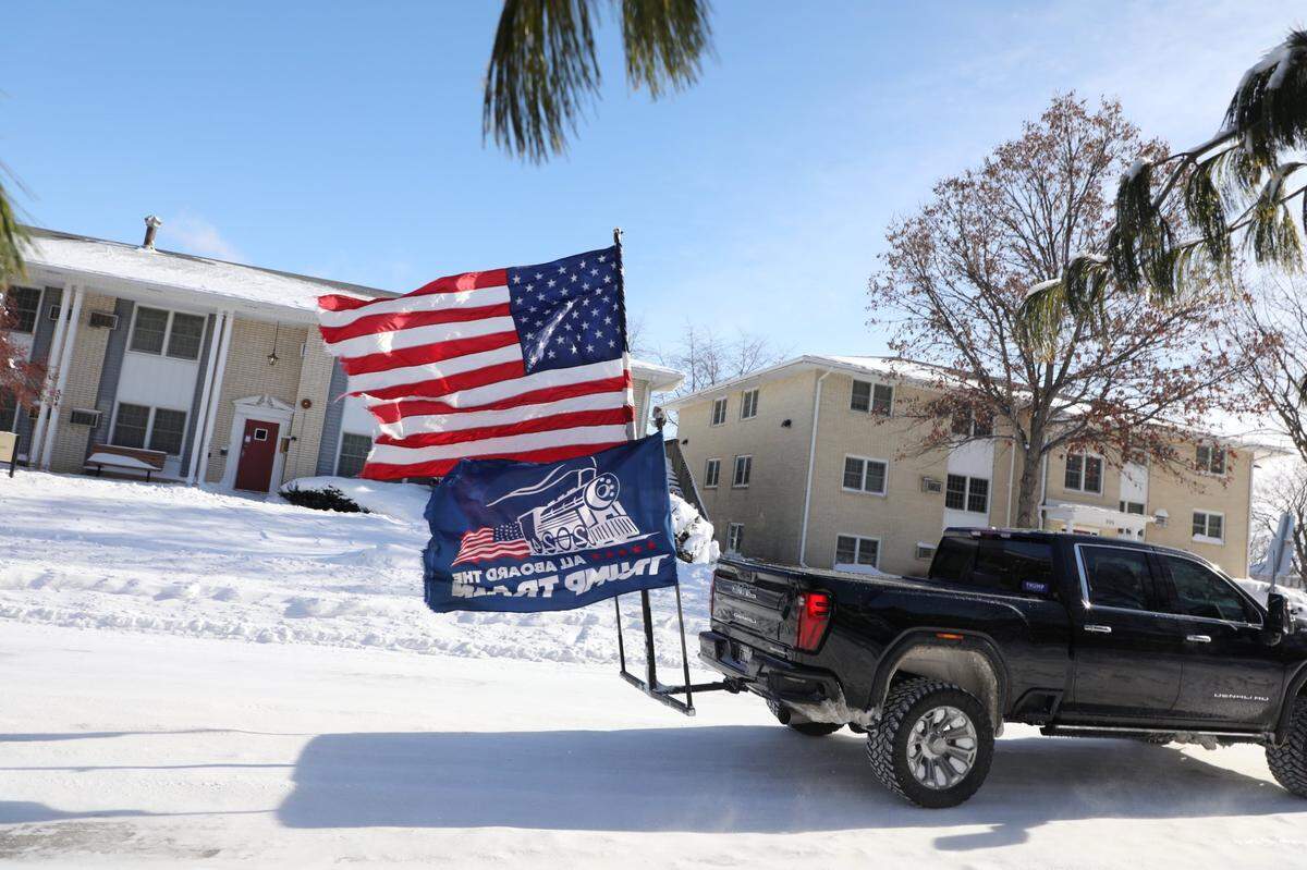 A pickup truck carries flags in support of former President Donald Trump near Simpson College where Trump spoke on Sunday, Jan 14, 2023, in Indianola, IA.