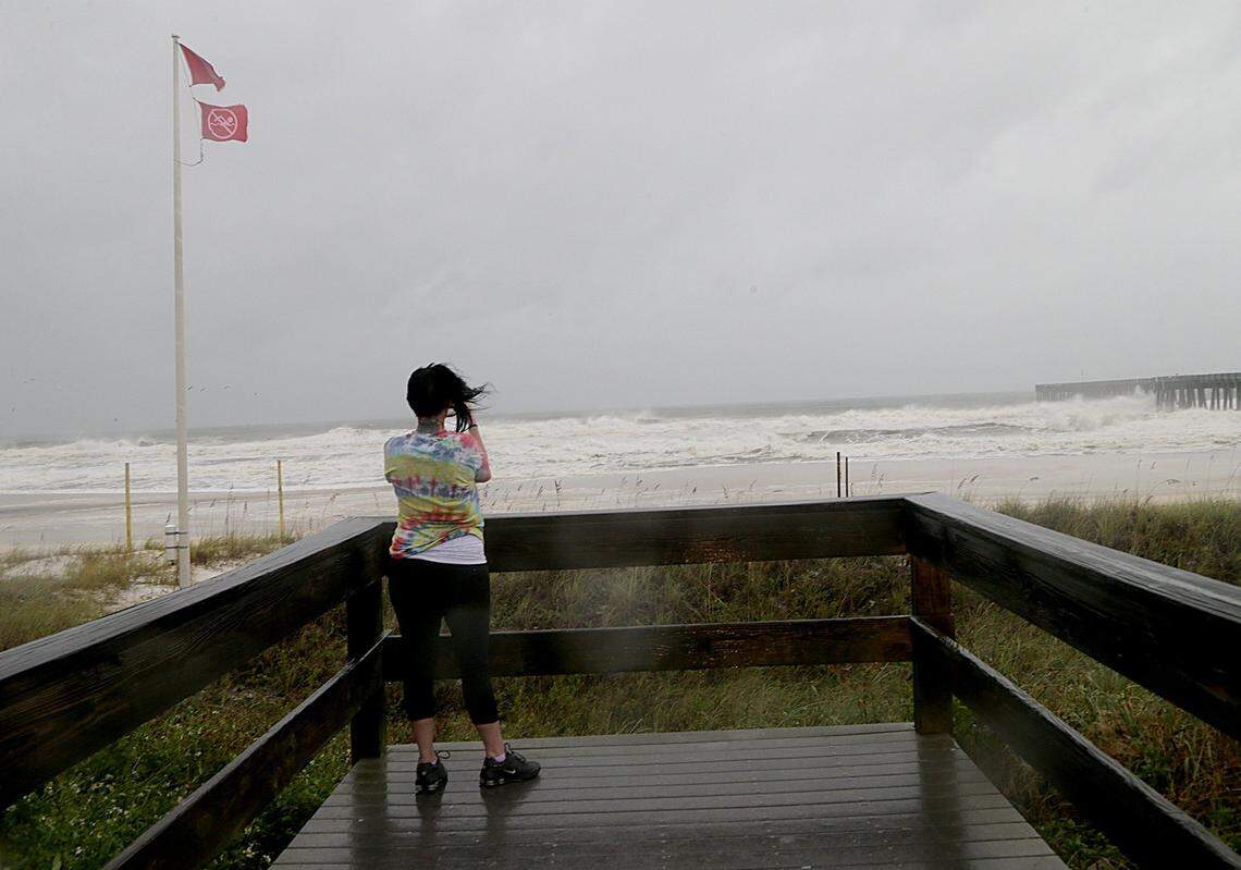 A woman snaps a picture on the city pier in Panama City, Florida, Wednesday morning before Hurricane Michael came ashore just east of Mexico Beach at 1 p.m. Central Daylight Time.