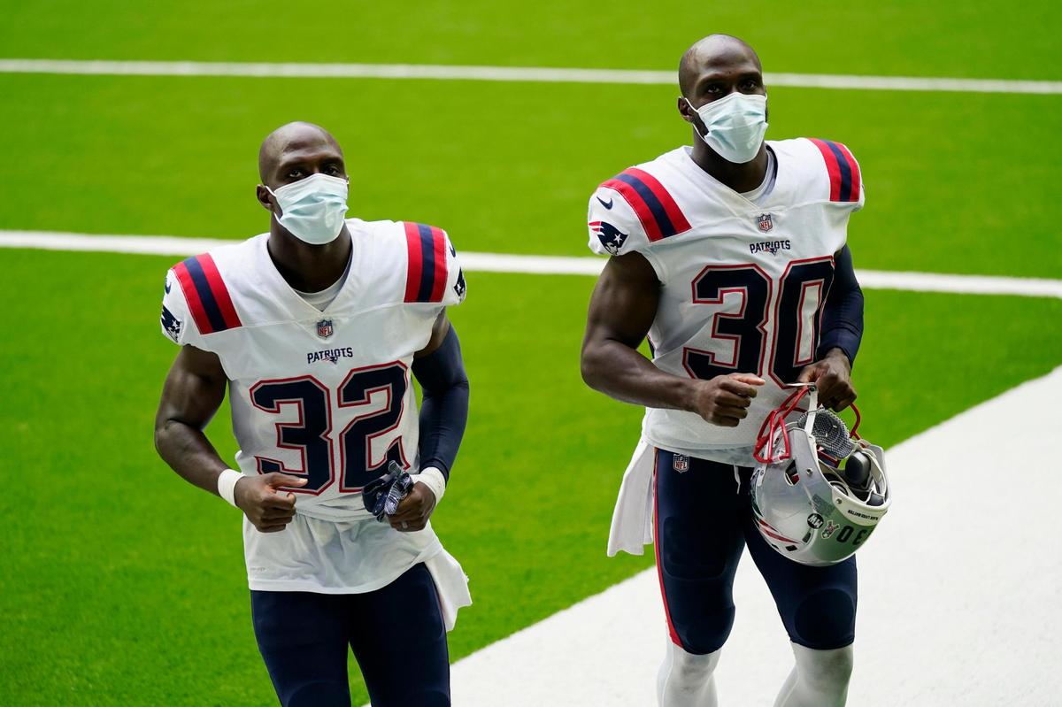 New England Patriots free safety Devin McCourty (32) and cornerback Jason McCourty (30) walk off the field after their loss to the Houston Texans an NFL football game, Sunday, Nov. 22, 2020, in Houston. (AP Photo/David J. Phillip)