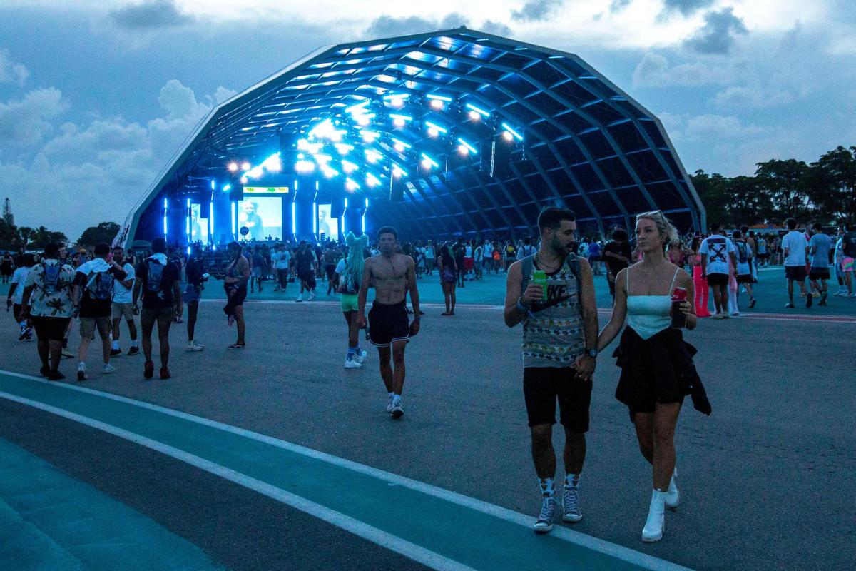 Festival goers walk the grounds during the first day of Rolling Loud Miami, an international hip-hop festival, at Hard Rock Stadium in Miami Gardens, Florida, on Friday, July 22, 2022.