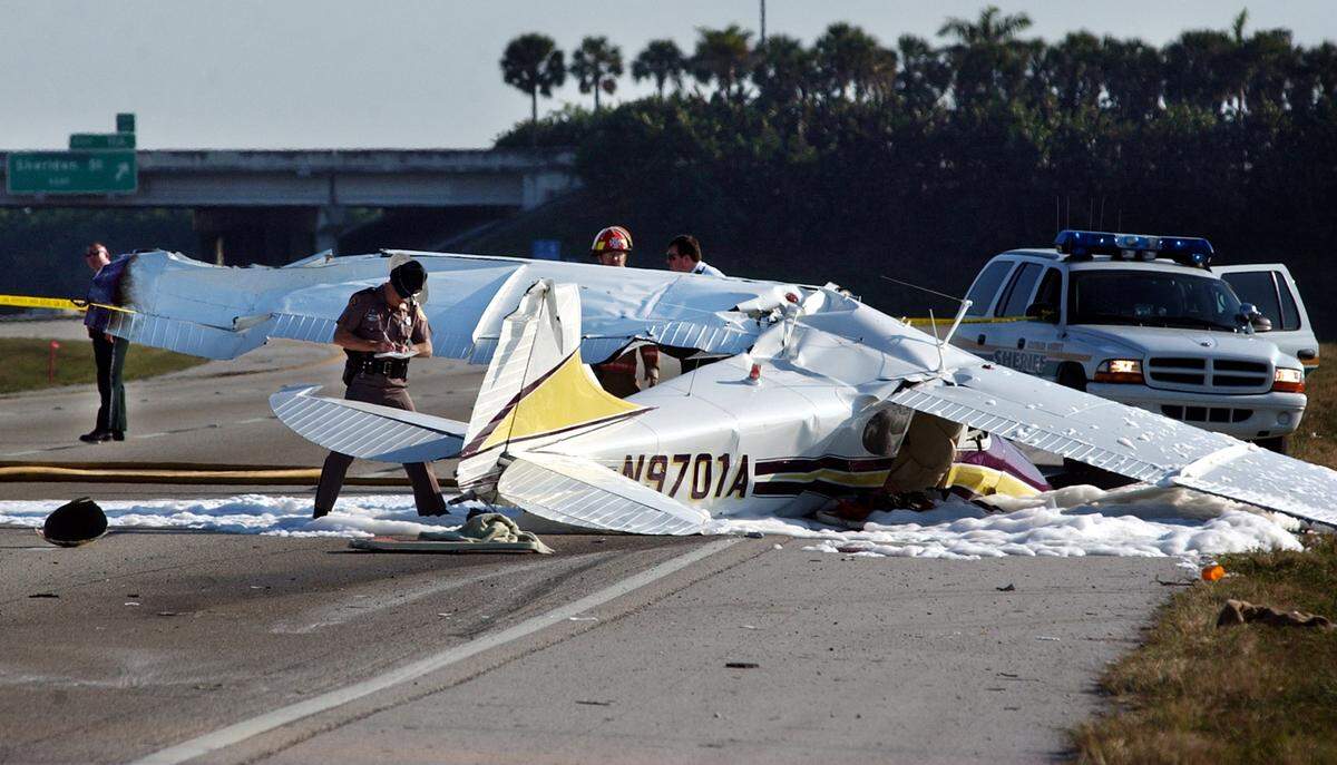 A father and daughter traveling in this small airplane crash-landed on southbound Interstate 75 just north of Sheridan Street after hitting a power line on Feb. 9, 2003. Neither person had life-threatening injuries. FHP, Davie police and Broward County responded to the scene that shut down southbound I-75 for hours.