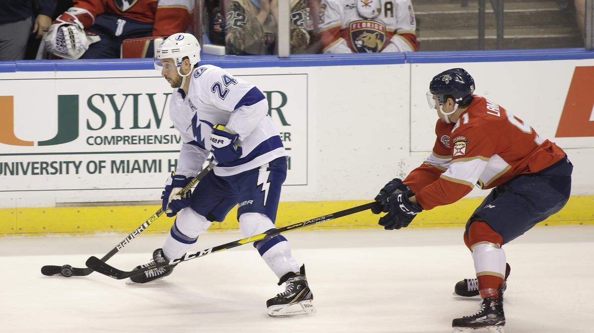 Tampa Bay Lightning right wing Ryan Callahan (24) and Florida Panthers right wing Juho Lammikko (91) fight for the puck during the first period of an NHL hockey game on Saturday, Dec. 1, 2018, in Sunrise, Fla. (AP Photo/Terry Renna)