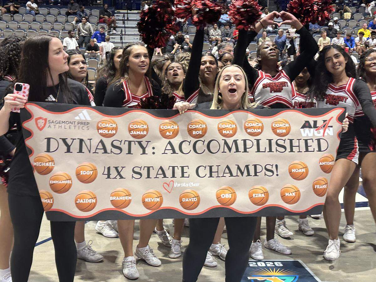 Sagemont Prep cheerleaders hold up a sign commemorating the Lions’ boys’ basketball team’s fourth consecutive state championship on Saturday at UNF Arena in Jacksonville, Fla.