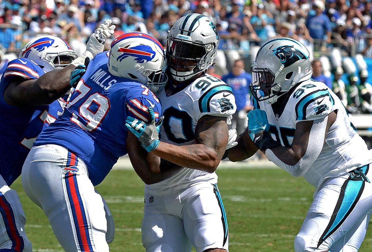 Carolina Panthers defensive end Julius Peppers, center, battles Buffalo Bills tackle Jordan Mills, left, during second quarter action on Sunday, September 17, 2017 at Bank of America Stadium in Charlotte, NC. The Panthers defeated the Buffalo Bills 9-3.