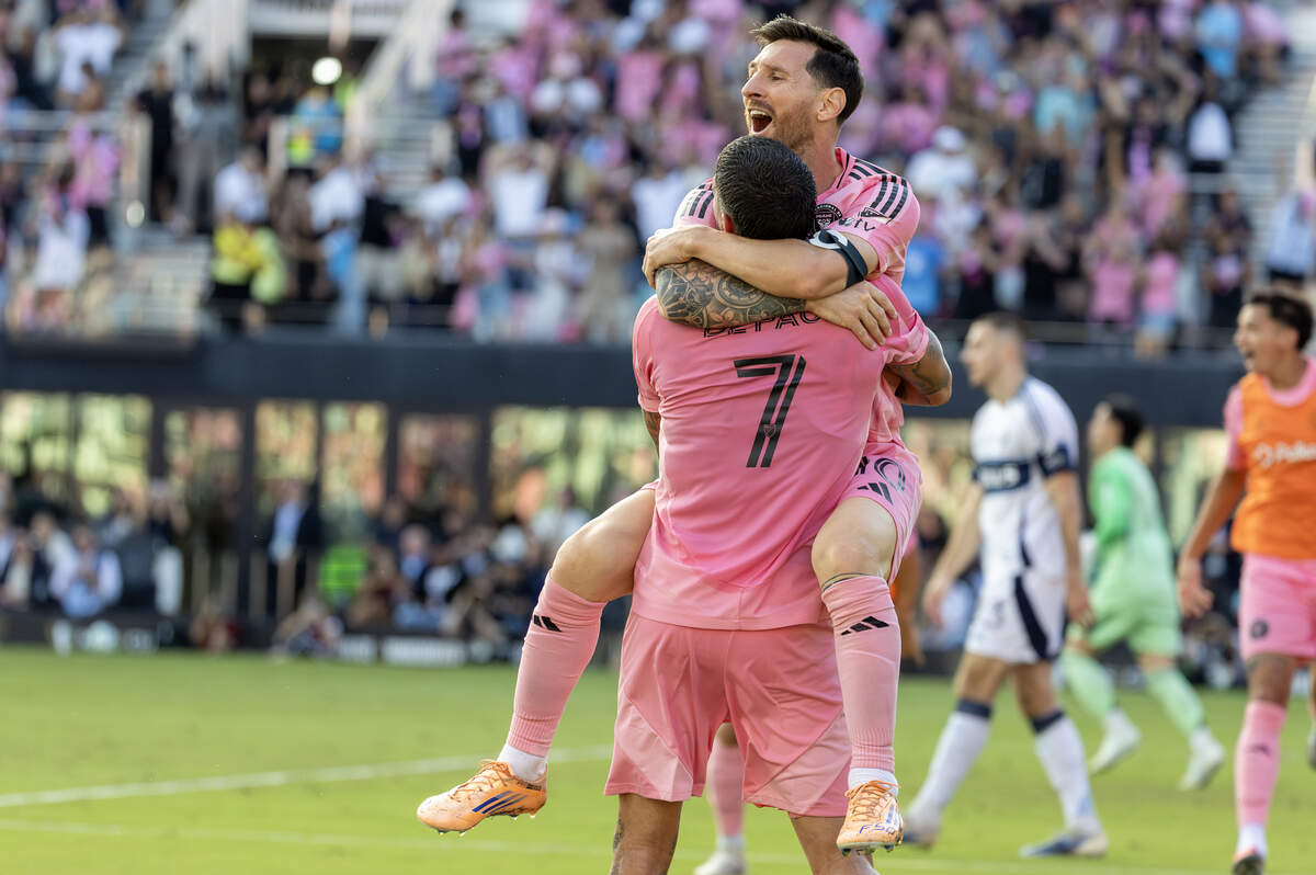 Inter Miami midfielder Rodrigo De Paul (7) celebrates with forward Lionel Messi (10) after scoring the go-ahead goal during the second half of the MLS Cup final against the Vancouver Whitecaps at Chase Stadium on Saturday, Dec. 6, 2025, in Fort Lauderdale, Fla.