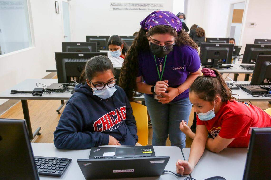 Kaylla Torres, lead instructor and program coordinator at Code/Art, helps her students with their classwork at the offices of the nonprofit in Miami on Monday, Oct. 4, 2021.