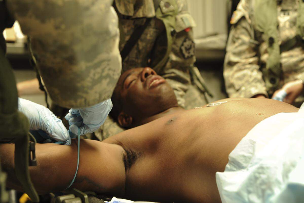 U.S. Army Pvt. Cecil Dean, 1st Battalion, 111th Engineering Company, is treated for heat exhaustion by Army medics of 2nd Squadron, 1st Cavalry, 4th Brigade, 2nd Infantry Division at Forward Operating Base Maimi, Fort Irwin, Calif., National Training Center, June 12, 2012. During NTC Army medics can expect to experience real world patients during training.