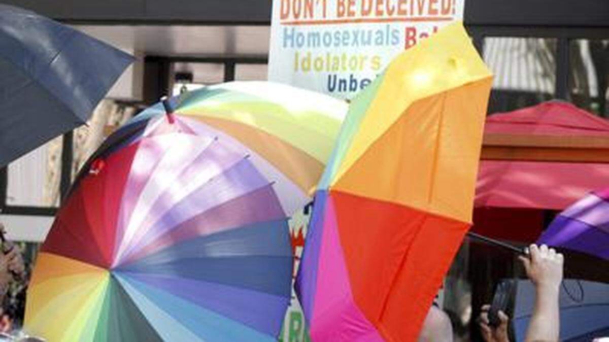In June, a protester carrying an anti-gay sign is surrounded by a sea of Pride umbrellas during the Pride parade in Winston-Salem, North Carolina.