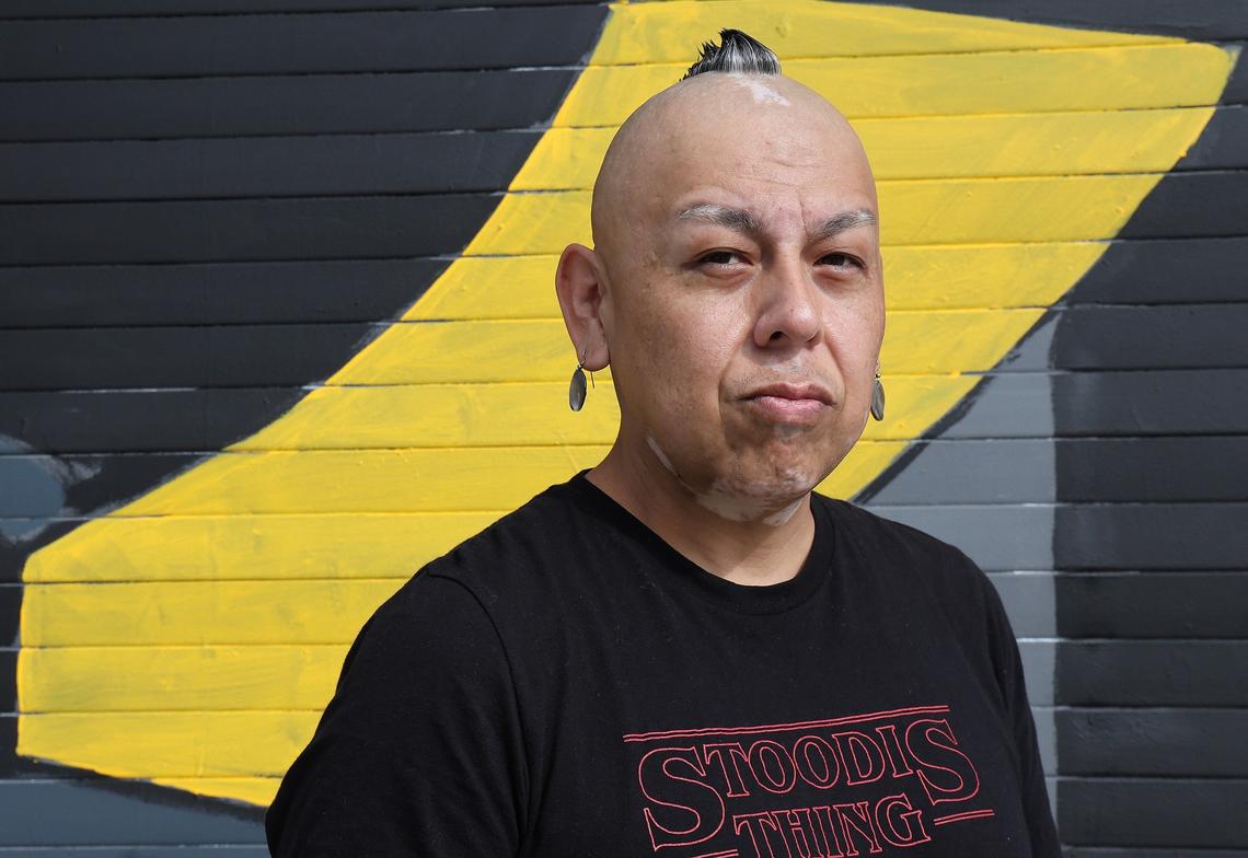 Native American artist Bunky Echo-Hawk stands near the mural that he created for the Miccosukee Tribe of Indians to showcase their history and preservation of the Everglades. The mural, unveiled Thursday in Wynwood, will be on display during Miami Art Week and Art Basel, beginning Dec. 2.