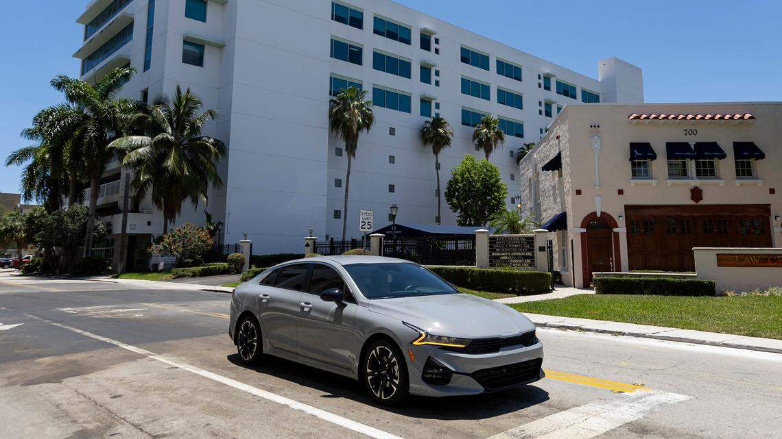 A car makes its way past Courthouse Place (left) in Fort Lauderdale, Fla., one of several properties purchased and later resold by Sefira Capital, which was accused by federal prosecutors of using laundered drug money to fund a real estate buying spree.
