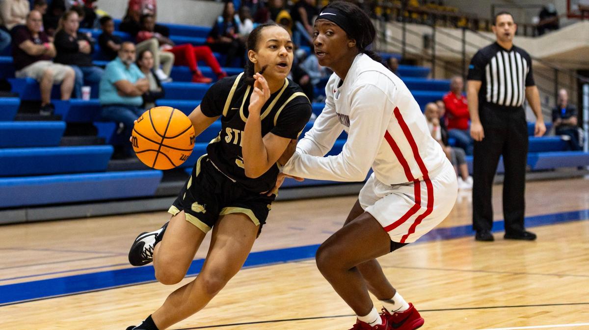 Miami High point guard Sydney Wilson (3) drives on Southridge forward Shanai Gamble (2) during the second half of the GMAC Basketball Finals at Miami-Dade Kendall campus gym in Miami, Florida on Saturday, January 27, 2024.