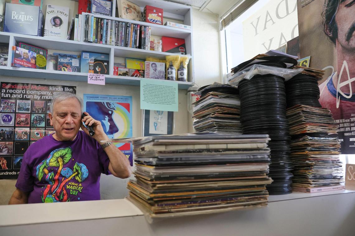 Yesterday and Today Records owner Evan Chern talks on the phone while working at his record store on west Bird Road at 9274 SW 40th St. in Miami, Florida, Friday, Feb. 2, 2024. Customers love talking music with this store owner.
