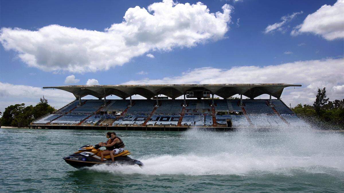 A personal water craft rider zooms past Miami marine Stadium in 2008.