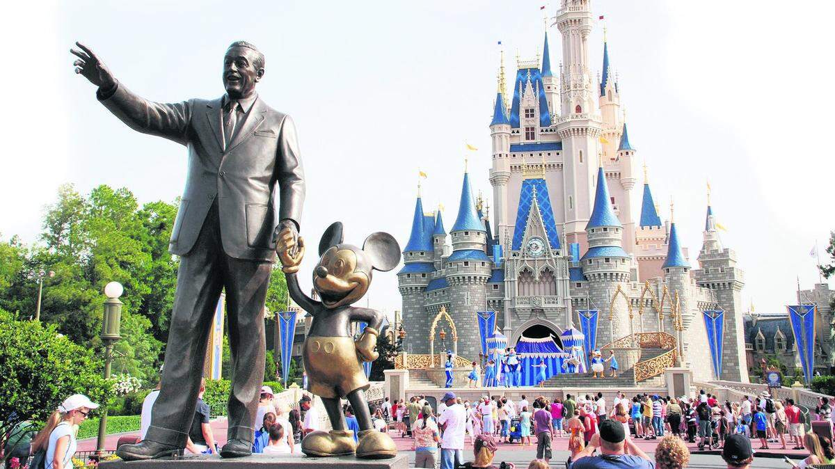 A statue of Walt Disney with Mickey Mouse outside the entrance to Cinderella’s Castle at Disney World in Orlando, Florida.