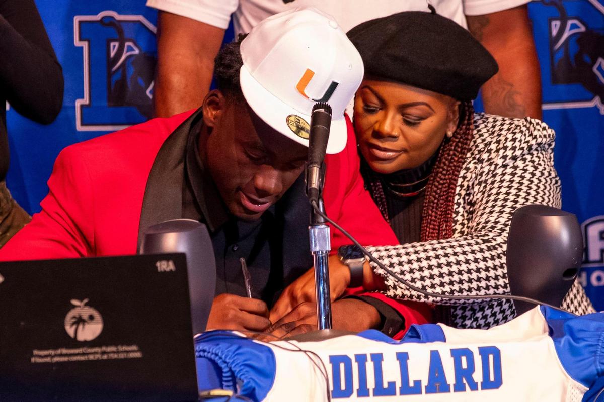 Four-star defensive lineman Nyjalik Kelly signs the dotted line with University of Miami football during early National Signing Day at Dillard High School in Fort Lauderdale, Florida, on Wednesday, December 15, 2021. Kelly made a recent decision to switch his school of choice from Oregon to Miami after the Hurricanes brought on Mario Cristobal as head coach.