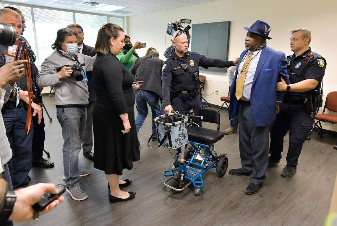 Ben Frazier, Jacksonville Northside Coalition founder, is handcuffed by a member of the Jacksonville Sheriff’s Office after refusing to leave the room where the press conference with the governor was to be held in Jacksonville, Fla., on Tuesday, Jan. 4, 2022.
