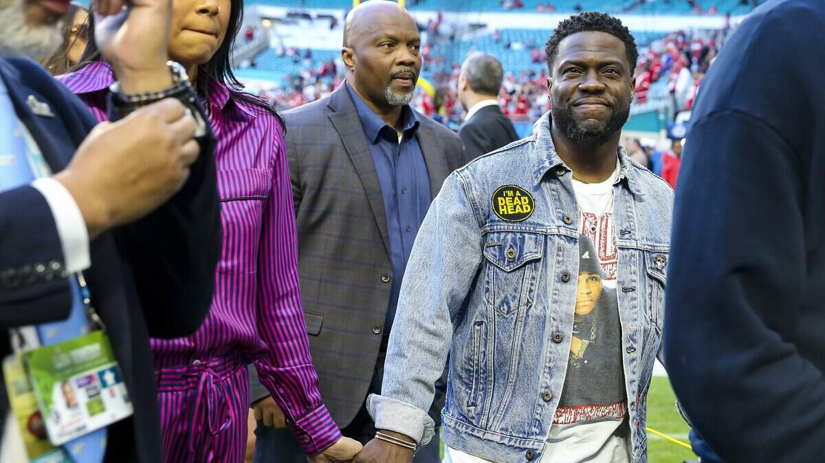 American comedian Kevin Hart arrives to the Hard Rock Stadium alongside his wife, Eniko Parrish, before the San Francisco 49ers face off against the Kansas City Chiefs during Super Bowl LIV on Sunday, February 2, 2020 in Miami Gardens, Florida.