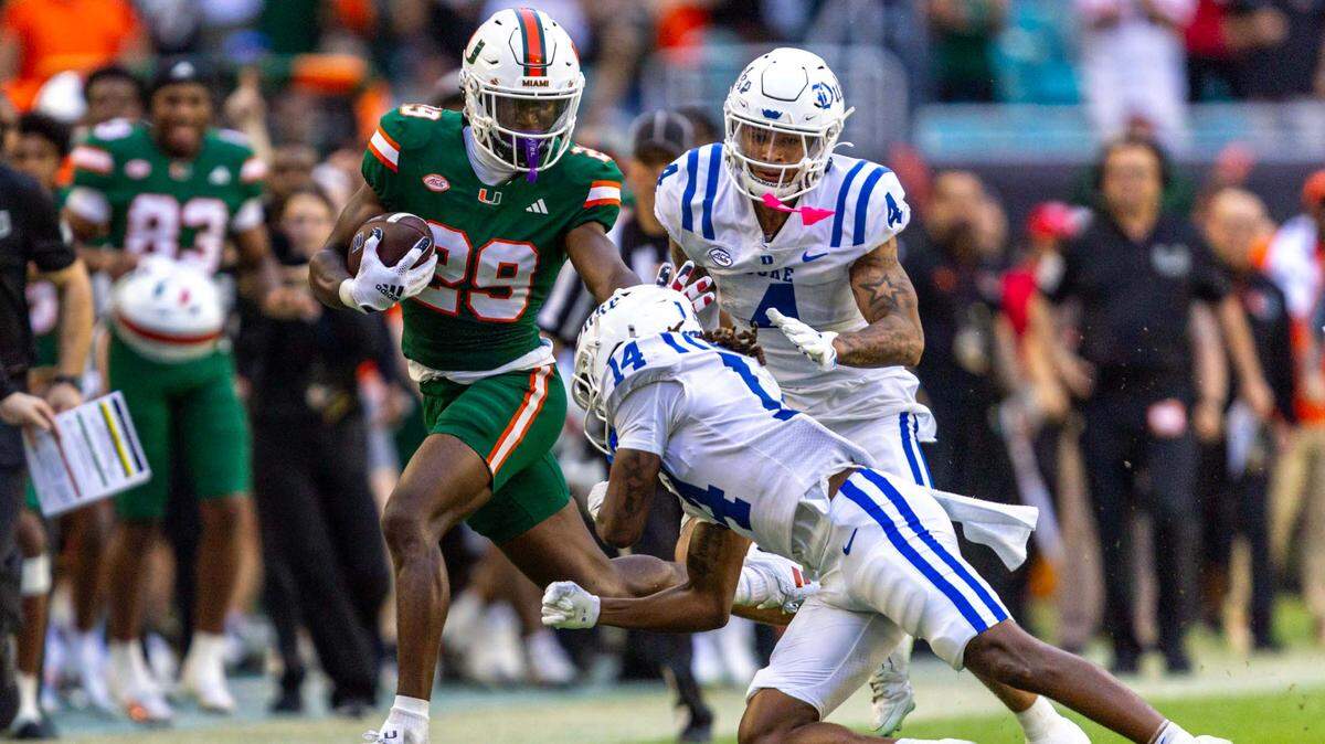 Miami Hurricanes defensive back OJ Frederique Jr. (29) stiff arms Duke Blue Devils wide receiver Que’Sean Brown (14) after intercepting a pass during the second half of an ACC football game at Hard Rock Stadium on Saturday, Nov. 2, 2024, in Miami Gardens, Fla.