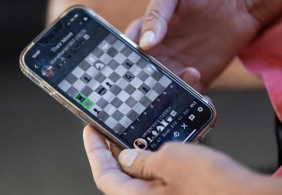 Gabriel Vergara, who lives with muscular dystrophy, likes to play chess on his mobile phone.