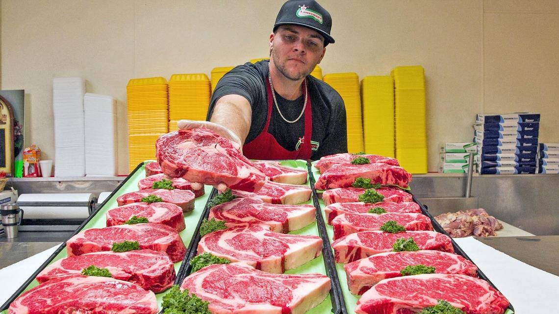 Vinnie ‘The Butcher’ Covillo displays the fresh cut steaks from Laurenzo’s Italian Market in North Miami Beach on Friday, June 22, 2018.